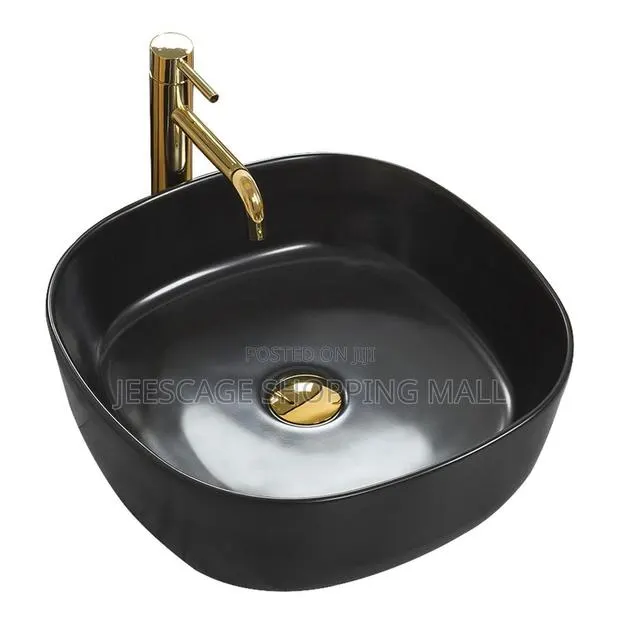 Modern Black Ceramic Vessel Sink With Gold Faucet and Drain Combo · Photo 1
