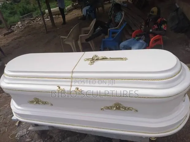 White Oval-Top Casket With Gold Trim · Photo 1