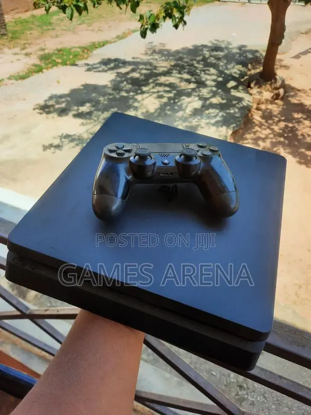 PS4 Slim With FC 27 and 7 Other Games + 2 Controllers · Photo 1