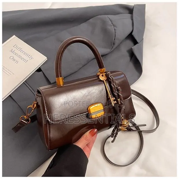Elegant Black Mini Top-Handle Bag With Keychain · Photo 1