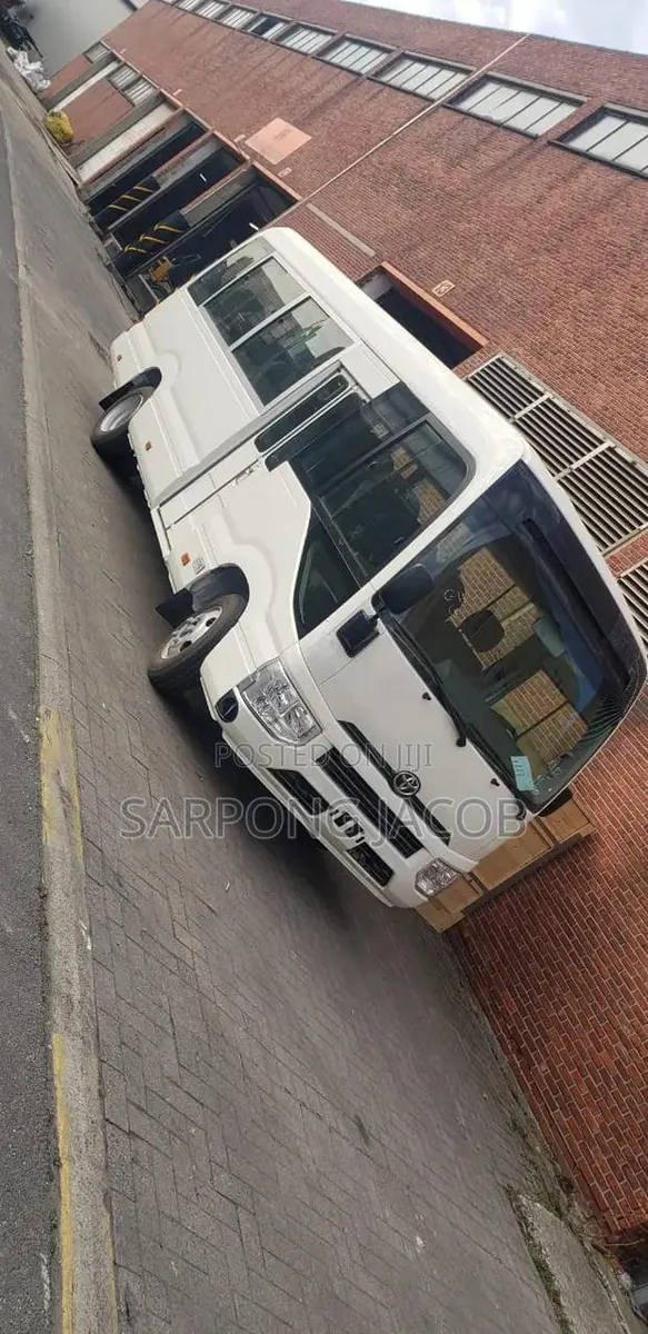New Toyota Coaster 2025 White · Photo 1