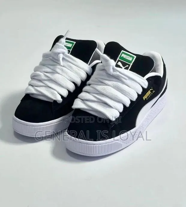 Puma Black and White Sneakers · Photo 1