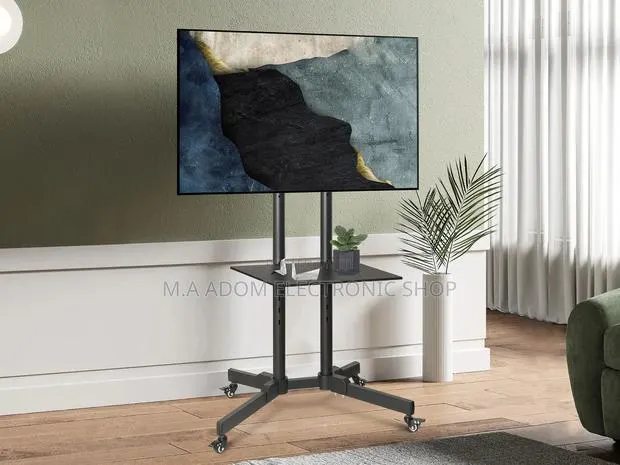 Movable Tv Stand Suitable for Tv Between 32”-70” · Photo 1