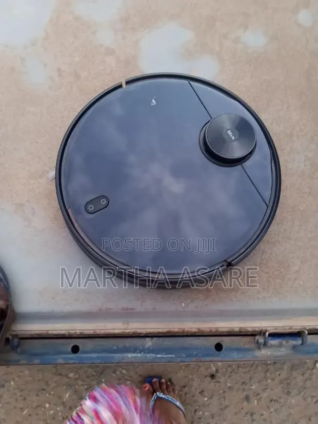 The Image Shows a Wyze Robot Vacuum, a Smart Automated Cleaning Device · Photo 1