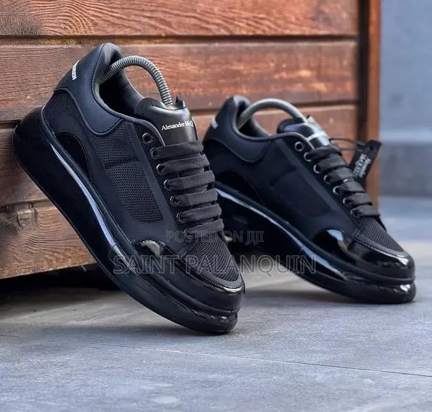 Black McQueen Low-Top Sneaker Wih a Thick Ridged Sole and a Mesh Upper · Photo 1